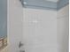 Clean, white-tiled shower and bathtub area with simple fixtures at 3100 Coachmans Way, Durham, NC 27705