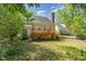 Lush backyard with wooden deck with lattice and stairs, and greenery offering privacy at 3109 E Folkestone Pl, Raleigh, NC 27604