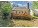 Exterior backyard showcasing a wooden deck, lattice detail, and cozy green space at 3109 E Folkestone Pl, Raleigh, NC 27604