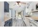 Well-lit kitchen with white cabinetry, modern appliances, and a view of the neighborhood at 3109 E Folkestone Pl, Raleigh, NC 27604