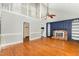 Inviting living room featuring hardwood floors, fireplace, and built-in shelving at 3109 E Folkestone Pl, Raleigh, NC 27604