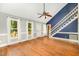 Bright living room with hardwood floors, large windows, and vaulted ceiling at 3109 E Folkestone Pl, Raleigh, NC 27604