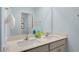 Well-lit bathroom with double sinks, quartz countertop, and modern fixtures at 320 Hanging Elm Ln, Fuquay Varina, NC 27526