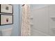 Clean bathroom featuring a shower with polka dot curtain, toilet, and wall art at 320 Hanging Elm Ln, Fuquay Varina, NC 27526