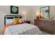 Tastefully decorated bedroom featuring a comfortable bed, dresser, and natural light at 320 Hanging Elm Ln, Fuquay Varina, NC 27526