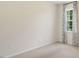 Bright bedroom with a window and neutral walls at 320 Hanging Elm Ln, Fuquay Varina, NC 27526