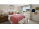 Bright bedroom featuring a cozy bed with colorful accents and natural light at 320 Hanging Elm Ln, Fuquay Varina, NC 27526