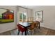 Bright dining room featuring modern decor, a black table, and access to the deck at 320 Hanging Elm Ln, Fuquay Varina, NC 27526
