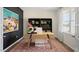 Stylish home office featuring a large desk, modern shelving, and a view outside at 320 Hanging Elm Ln, Fuquay Varina, NC 27526
