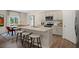 Bright and airy kitchen featuring a center island with seating, stainless steel appliances and dining area at 320 Hanging Elm Ln, Fuquay Varina, NC 27526