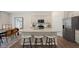 Modern kitchen with granite countertops, island seating, stainless appliances and a dining space at 320 Hanging Elm Ln, Fuquay Varina, NC 27526
