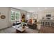 Cozy living room featuring a comfortable sofa, a window, and an open view to the kitchen at 320 Hanging Elm Ln, Fuquay Varina, NC 27526