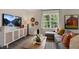 Relaxing living room featuring a TV, a window, and a comfortable seating area at 320 Hanging Elm Ln, Fuquay Varina, NC 27526