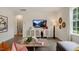 Comfortable living room with a TV, a window, and neutral colors at 320 Hanging Elm Ln, Fuquay Varina, NC 27526
