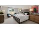 Elegant bedroom featuring a stylish bed, sitting area and large window view at 320 Hanging Elm Ln, Fuquay Varina, NC 27526