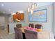 Dining area next to the kitchen with modern light fixtures and views to other rooms at 3219 Ranbir Dr, Durham, NC 27713