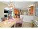 Open concept dining room with a wooden table, purple chairs, and modern lighting at 3219 Ranbir Dr, Durham, NC 27713