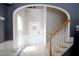 Bright foyer features an arched doorway, staircase, and a front door decorated for Easter at 3219 Ranbir Dr, Durham, NC 27713