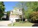 Charming two-story home featuring a stone veneer, attached two-car garage, and well-manicured lawn at 3219 Ranbir Dr, Durham, NC 27713
