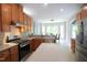 Modern kitchen with stainless steel appliances, wood cabinets, and an island with a white countertop at 3219 Ranbir Dr, Durham, NC 27713