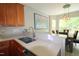 Well-equipped kitchen with stainless steel appliances, wood cabinets, and modern countertops adjacent to dining area at 3219 Ranbir Dr, Durham, NC 27713