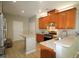 Contemporary kitchen featuring wooden cabinets, stainless steel appliances, and an island with a breakfast bar at 3219 Ranbir Dr, Durham, NC 27713