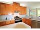 Well-lit kitchen with wooden cabinetry, stainless steel appliances, and modern countertops at 3219 Ranbir Dr, Durham, NC 27713