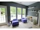 Bright living room with a fireplace, floating shelves, and large windows overlooking the outdoor deck at 3219 Ranbir Dr, Durham, NC 27713