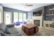 Spacious living room featuring a fireplace, ceiling fan, and backyard access through glass doors at 3219 Ranbir Dr, Durham, NC 27713