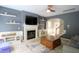 Cozy living room showcasing a fireplace, mounted TV, and neutral walls with an arched entryway at 3219 Ranbir Dr, Durham, NC 27713