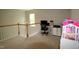 Upstairs loft featuring neutral carpeting, a hanging light fixture, and an office area at 3219 Ranbir Dr, Durham, NC 27713