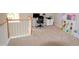 Upstairs loft featuring neutral carpeting, a desk, and storage shelves for toys at 3219 Ranbir Dr, Durham, NC 27713