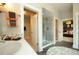 Well-lit bathroom featuring a glass-enclosed shower, open doorway to bedroom and sink at 33 Blackhorn Ct, Pittsboro, NC 27312