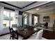 Elegant dining room showcasing modern lighting, dark accent paint, and view into the study at 33 Blackhorn Ct, Pittsboro, NC 27312