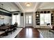 Open-concept entryway featuring hardwood floors, custom shelving, and elegant dining area at 33 Blackhorn Ct, Pittsboro, NC 27312