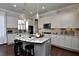 Modern kitchen with granite countertops, a center island with seating, and stainless steel appliances at 33 Blackhorn Ct, Pittsboro, NC 27312