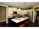 This modern kitchen features an island, stainless steel appliances, and contrasting dark and light cabinets at 33 Blackhorn Ct, Pittsboro, NC 27312