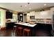 This modern kitchen features an island, stainless steel appliances, and contrasting dark and light cabinets at 33 Blackhorn Ct, Pittsboro, NC 27312