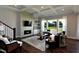 Modern living room with fireplace, TV and outside views at 33 Blackhorn Ct, Pittsboro, NC 27312