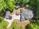 Lush landscaping surrounds this spacious estate, showcasing a circular driveway and accessory structures at 3513 Forest Oaks Dr, Chapel Hill, NC 27514