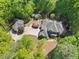Beautiful estate surrounded by lush trees features a circular driveway and detached building at 3513 Forest Oaks Dr, Chapel Hill, NC 27514