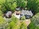 Expansive estate featuring lush landscaping, a circular driveway, and two additional detached buildings at 3513 Forest Oaks Dr, Chapel Hill, NC 27514