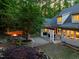 Expansive backyard features a fire pit area, pergola-covered patio, and lush landscaping at 3513 Forest Oaks Dr, Chapel Hill, NC 27514