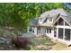 Backyard featuring a patio, screened porch, fire pit, and lush landscaping at 3513 Forest Oaks Dr, Chapel Hill, NC 27514