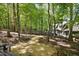 Lush backyard and pathway leading to the home, with mature trees and natural surroundings at 3513 Forest Oaks Dr, Chapel Hill, NC 27514
