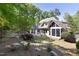 Lush backyard with stone steps, fire pit, patio, screened porch, and landscaping at 3513 Forest Oaks Dr, Chapel Hill, NC 27514