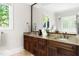 Elegant bathroom with double vanity, granite countertops, and a large mirror at 3513 Forest Oaks Dr, Chapel Hill, NC 27514