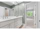 Elegant bathroom with double vanity, ample storage and a view of the bedroom at 3513 Forest Oaks Dr, Chapel Hill, NC 27514