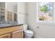 Bathroom featuring granite countertops, wood cabinetry, and a tiled shower with glass door at 3513 Forest Oaks Dr, Chapel Hill, NC 27514