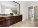 Luxurious bathroom with double vanity, granite countertops, large mirror, and elegant tile flooring at 3513 Forest Oaks Dr, Chapel Hill, NC 27514
